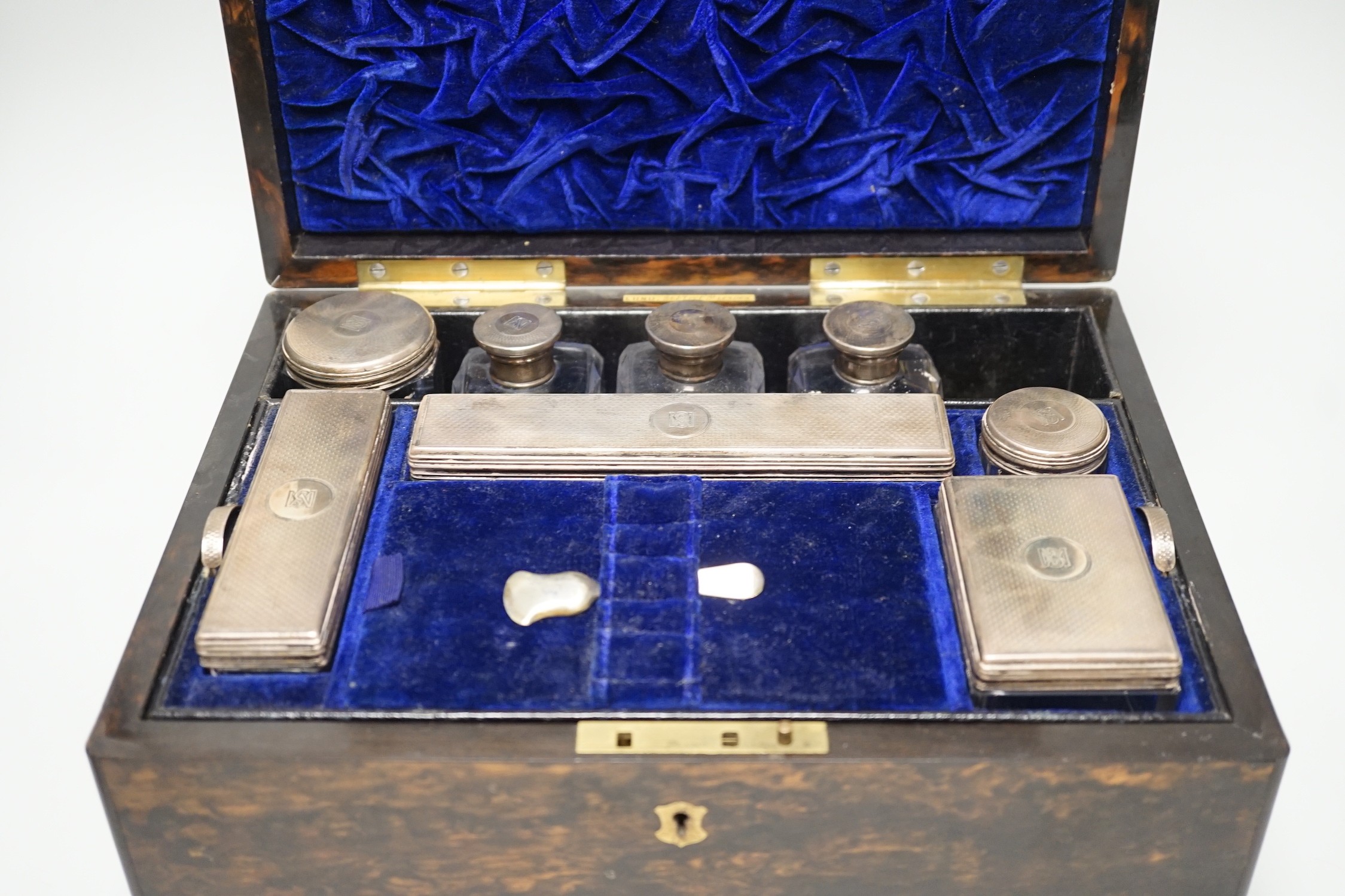 A Victorian brass mounted coromandel wood travelling toilet box, containing eight silver mounted glass toilet jars, all with engraved monogram, Frances Douglas, London, 1851, box width 30.5cm (incomplete and a.f.).